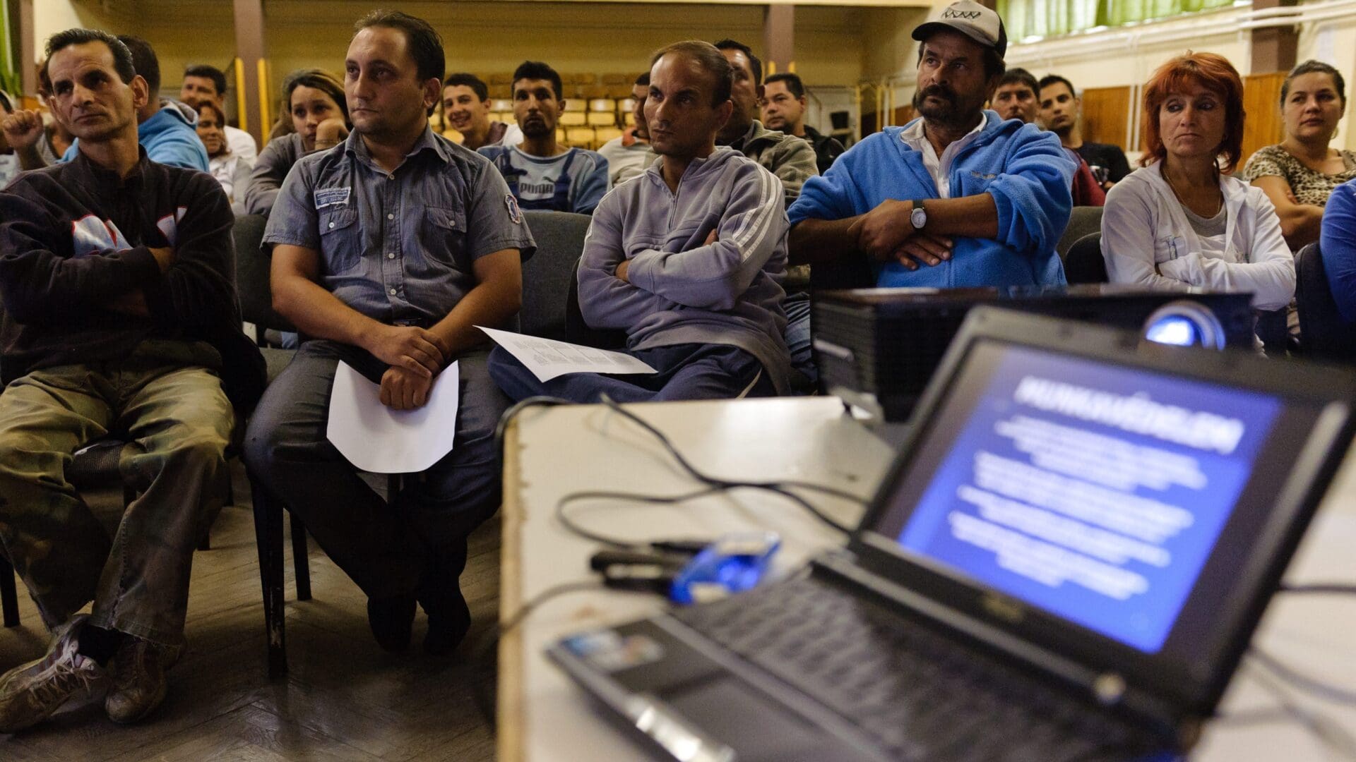 Roma public workers listen to a job safety briefing on 1 August 2011 in Gyöngyöspata, Heves County.