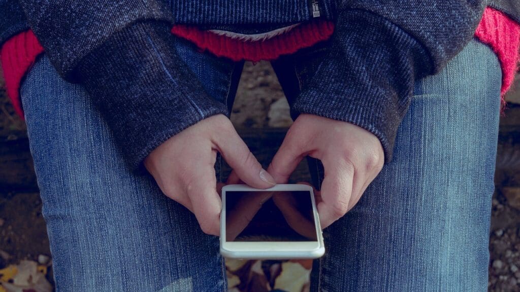 Young person holding a mobile phone