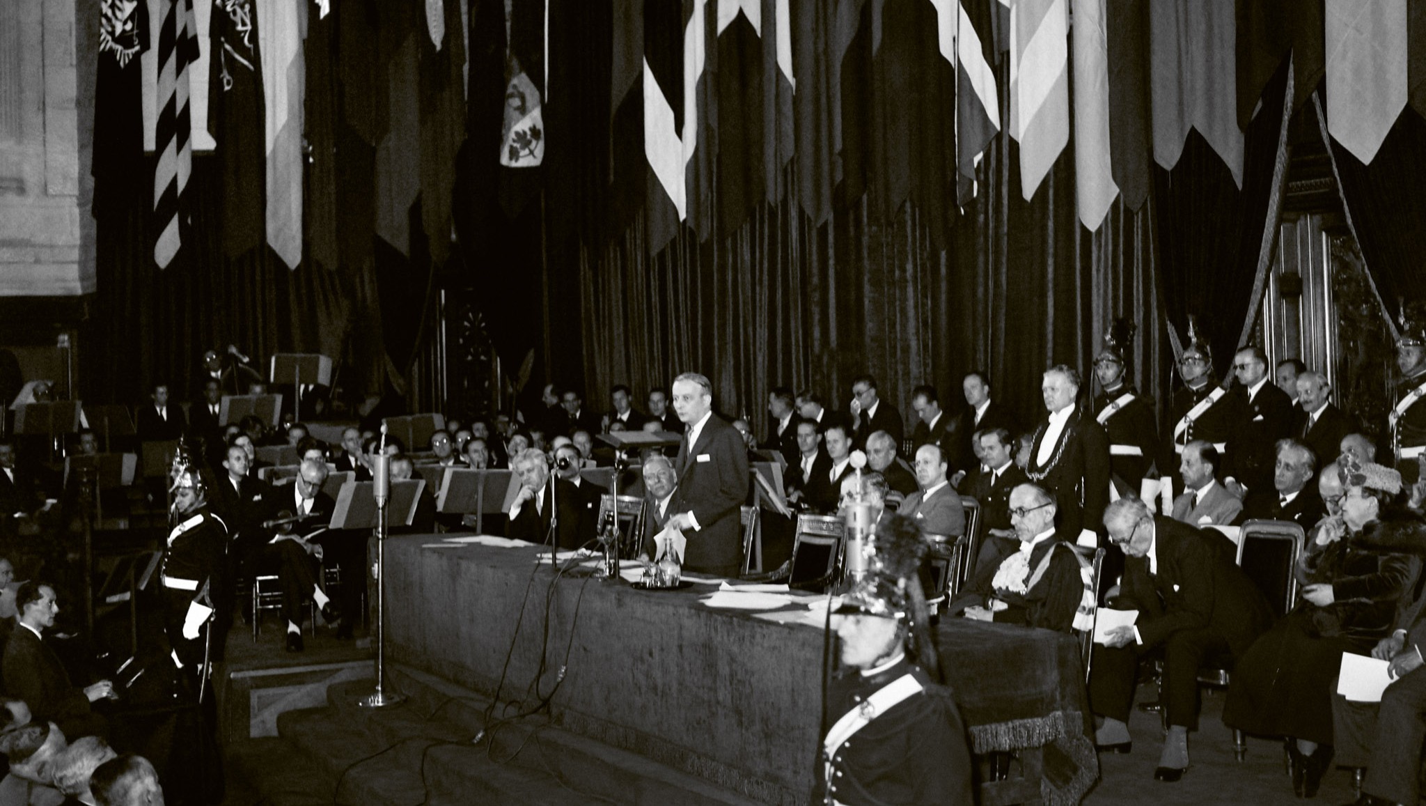President of the Provisional Government of the French Republic Georges Bidault (standing) delivers a speech with Director-General of UNESCO Sir Julian Huxley (R) at the UNESCO conference in Paris, France, 19 November 1946