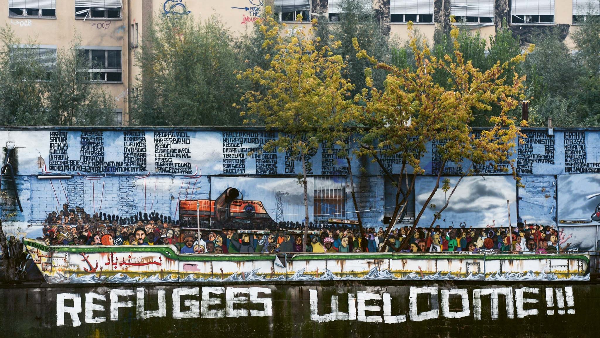 Willkomennskultur – View of an old apartment block with ‘Refugees Welcome!!!’ mural, Berlin, Germany, 26 October 2016