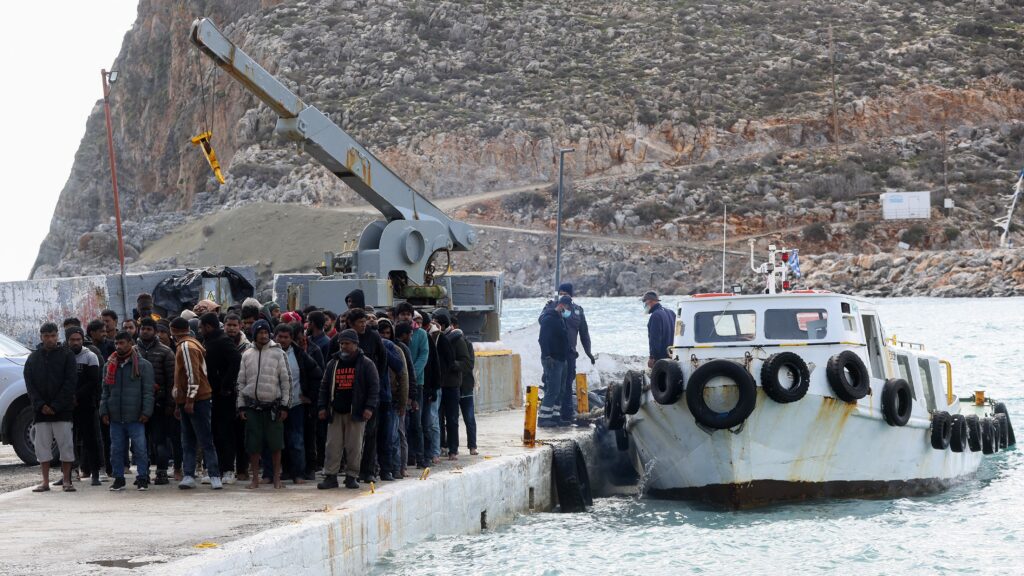 Migrants disembark from a boat at the port of Kali Limenes, in Heraklion, southern Crete, on February 21, 2026.