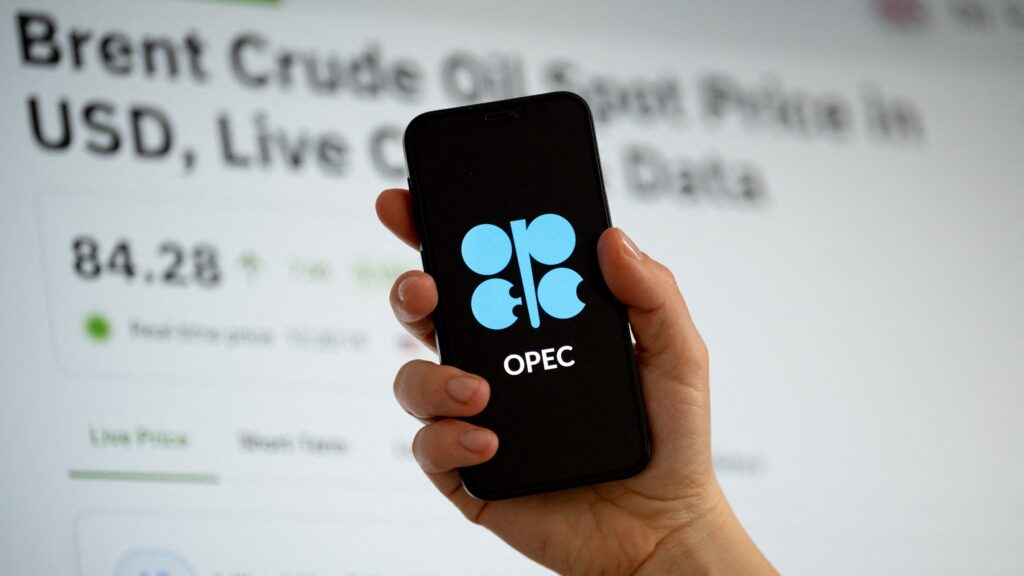 The Organization of the Petroleum Exporting Countries (OPEC) logo is displayed on a mobile phone screen, and a website with a Brent crude oil price chart is seen on a computer screen in Krakow, Poland, on March 3, 2026.