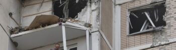 Local residents inspect a damaged balcony in a residential building following an air attack in Krasnogorsk, Moscow region on May 17, 2026, amid the ongoing Russian-Ukrainian conflict.